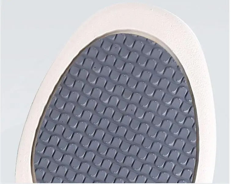 Close-up of the grey, wave-patterned rubber outsole of Fitlybuy ComfortStride orthopedic walking shoes.