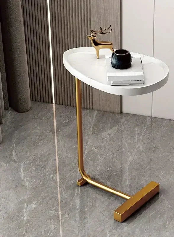 Modern Fitlybuy side table with an oval white faux-marble top and gold metal frame on a grey tiled floor.
