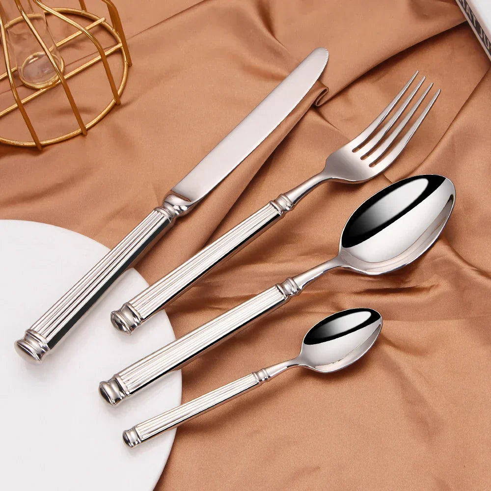 Fitlybuy premium 304 stainless steel cutlery set with mirror finish and elegant ribbed handles on a gold silk fabric.