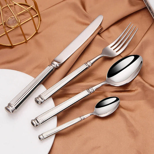Fitlybuy premium 304 stainless steel cutlery set with mirror finish and elegant ribbed handles on a gold silk fabric.