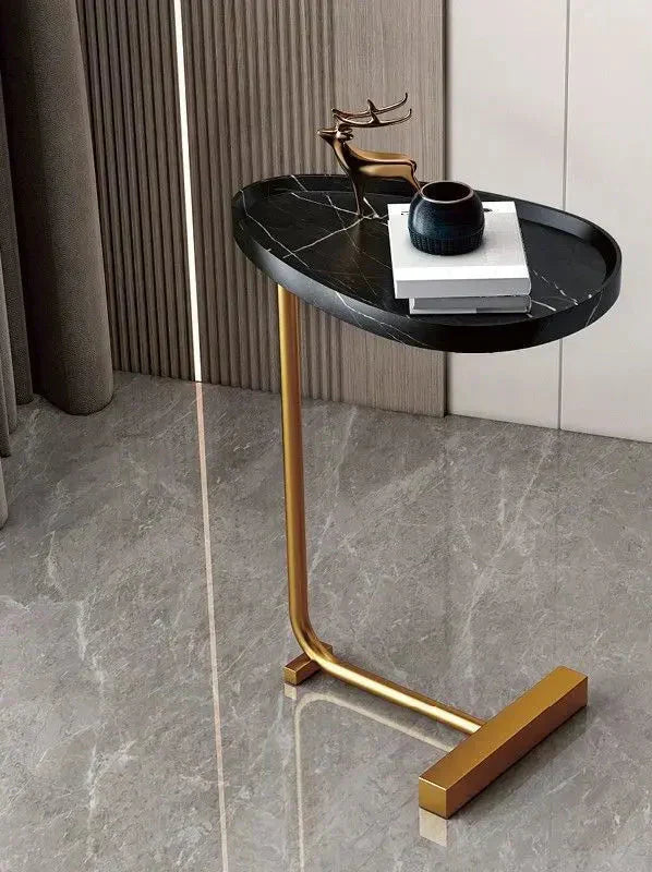 Fitlybuy modern side table with a black marble oval top and gold metal C-frame base, styled in a luxury living room.