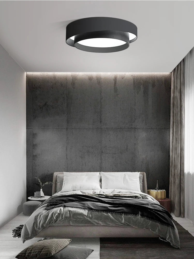 Fitlybuy NordicAura minimalist black LED ceiling light with circular, tiered design installed in a modern bedroom.
