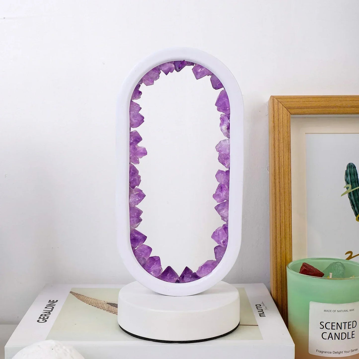 Fitlybuy AuraStone oval lamp with raw purple amethyst crystals set in a white frame, displayed on a desk with decor.