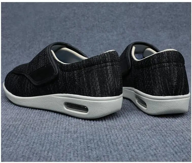 Fitlybuy black orthopedic walking shoes with Velcro straps, white cushioned soles, and visible air arch support units.