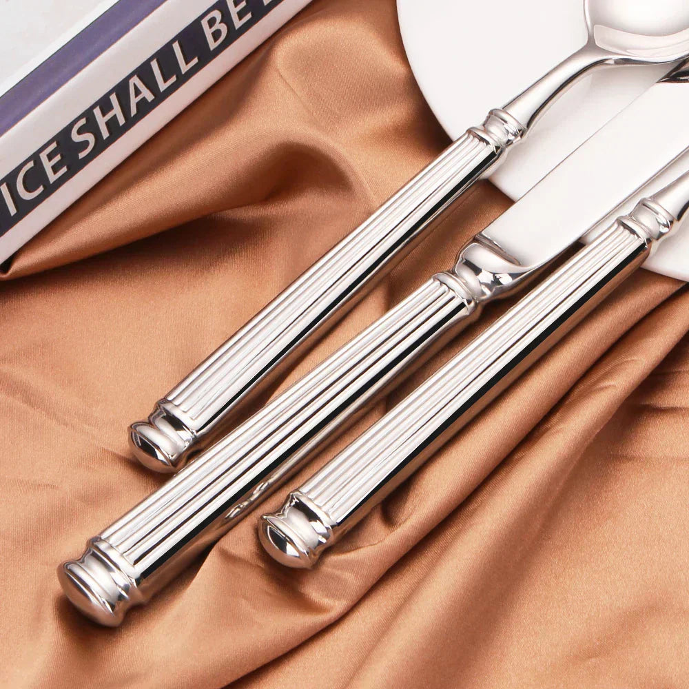 Fitlybuy 304 stainless steel cutlery set with mirror finish and elegant ribbed handles on a gold silk fabric background.