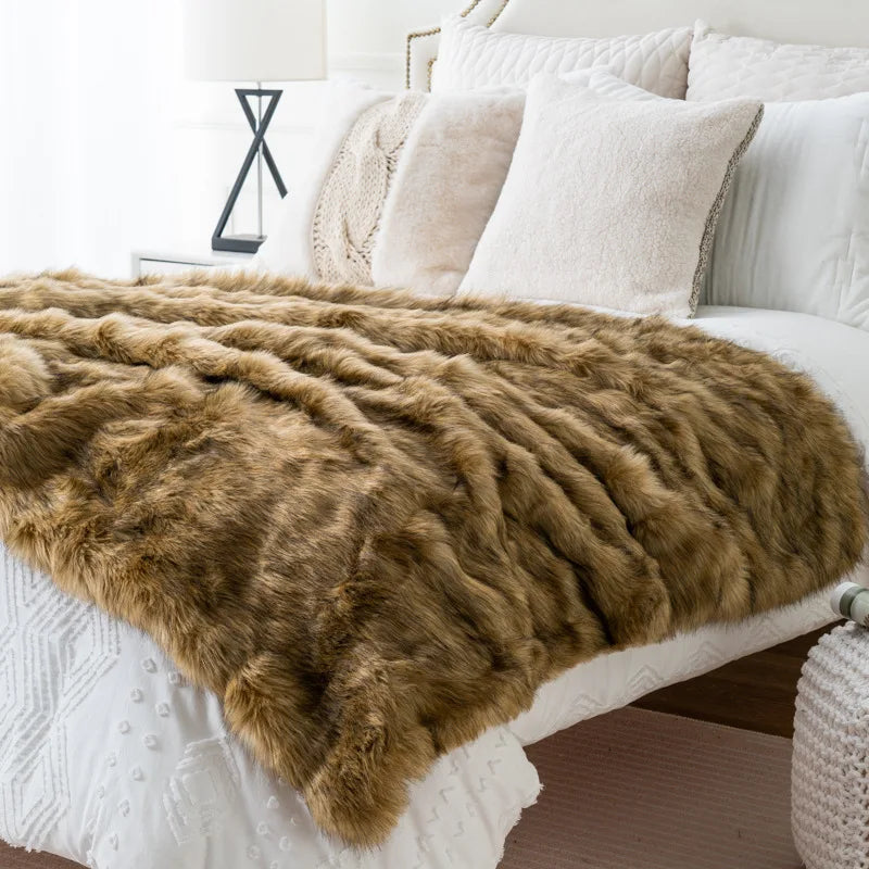 Fitlybuy brown luxury faux fox fur throw blanket, draped over a white bed with pillows in a bright bedroom.