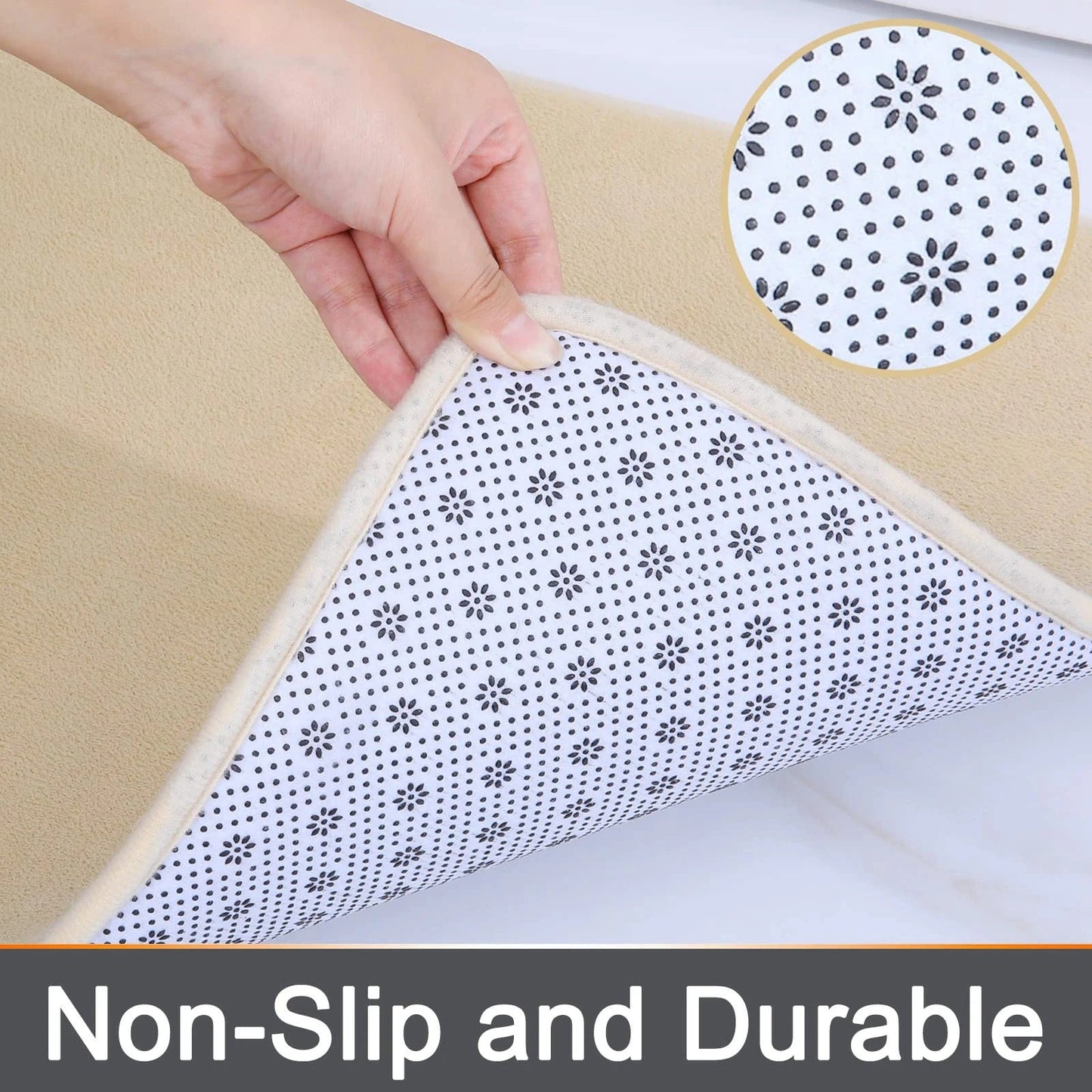 Hand holding a beige Fitlybuy memory foam bath mat with a non-slip, flower-patterned backing.