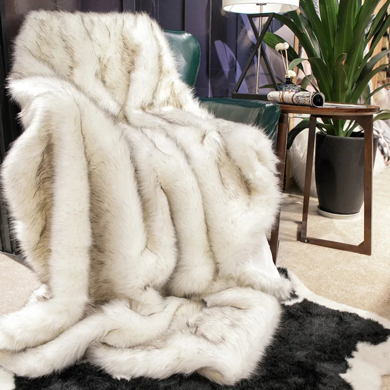 Fitlybuy faux fox fur throw blanket in ivory with charcoal tipped texture, draped over a green chair in a modern room.