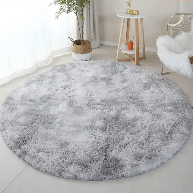 Fitlybuy FluffyMat round rug in light gray plush, placed in a bright, modern living room setting.