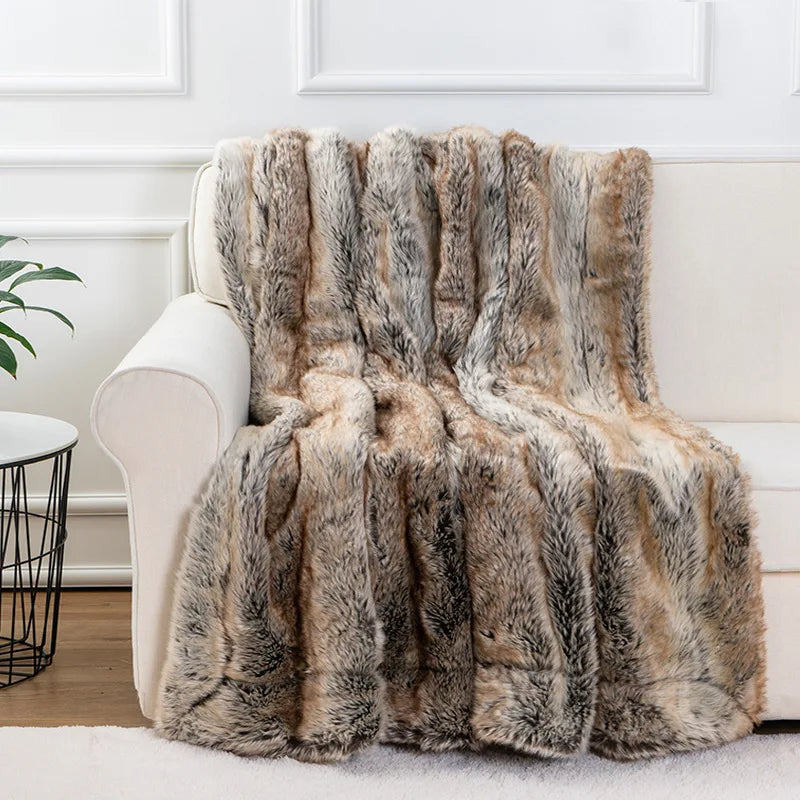 Fitlybuy luxurious mink faux fur throw blanket in a brown, grey, and cream striped pattern draped over a white sofa.
