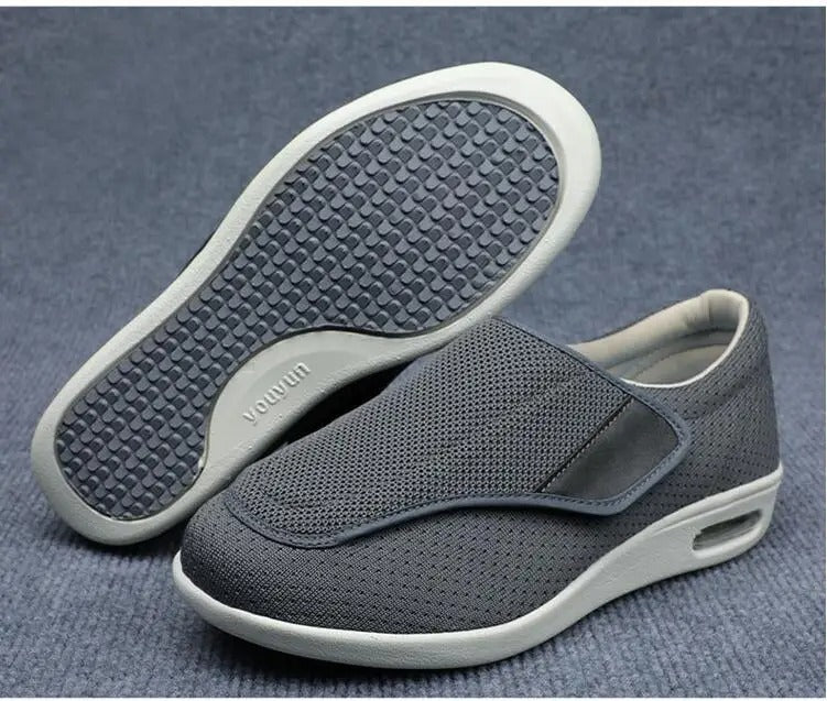 Grey Fitlybuy ComfortStride orthopedic walking shoes with breathable mesh, velcro closure, and cushioned arch soles.