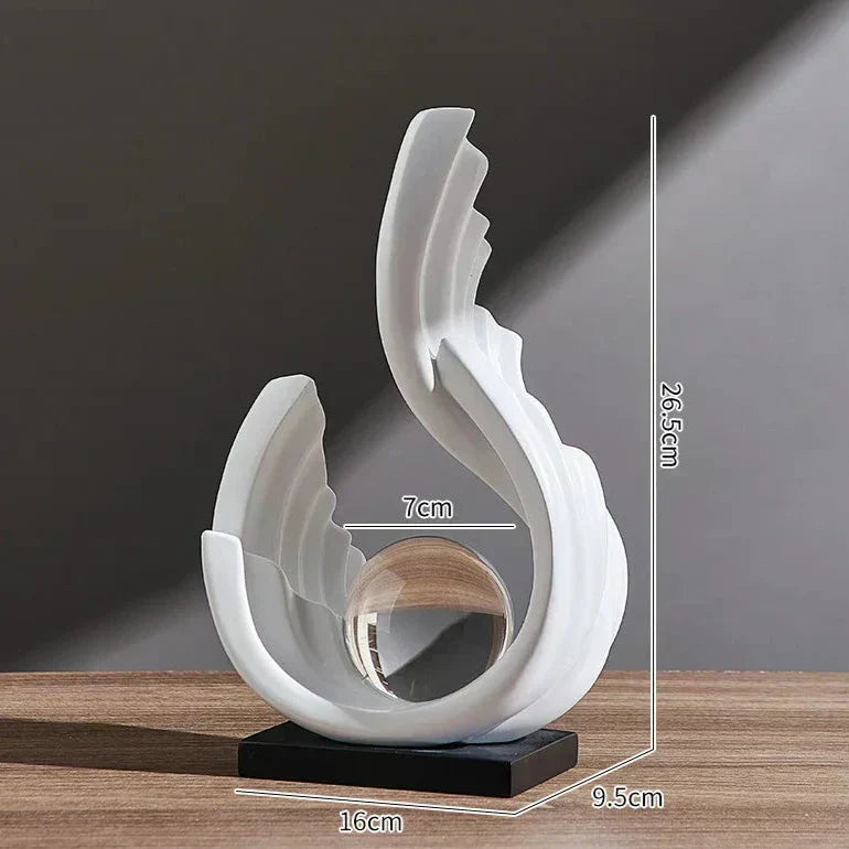 White abstract wave ornament with a central clear glass sphere on a black base, showing 26.5cm, 16cm, and 7cm dimensions.
