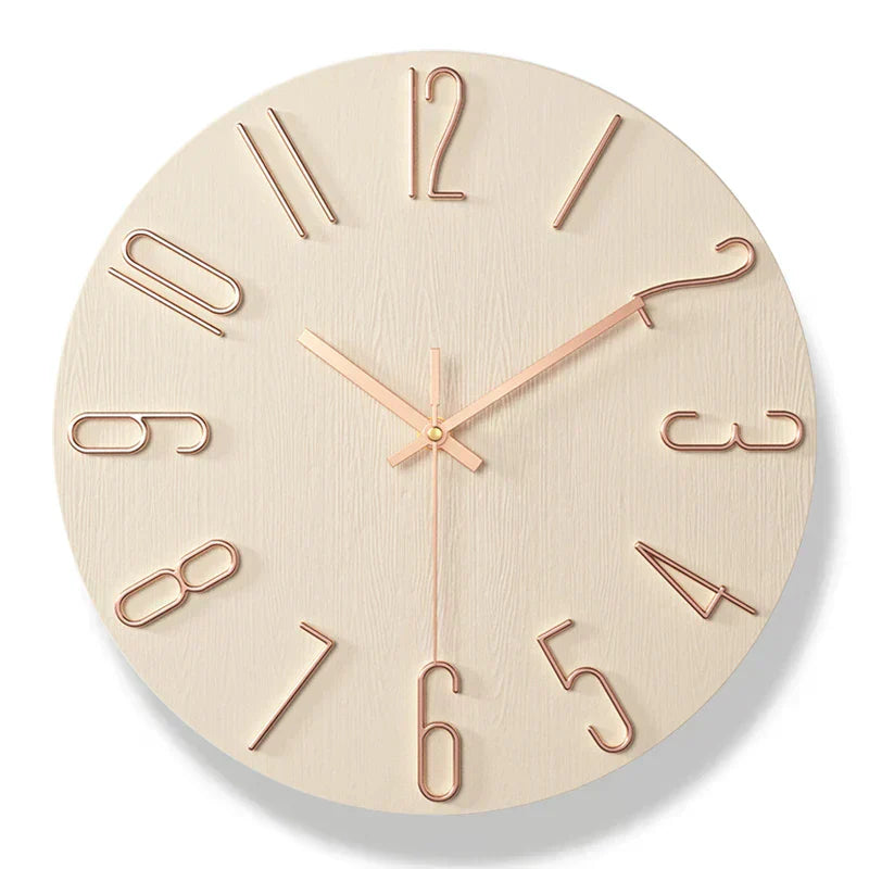 Scandinavian frameless wooden wall clock with rose gold metallic numbers and hands on a light wood grain background.