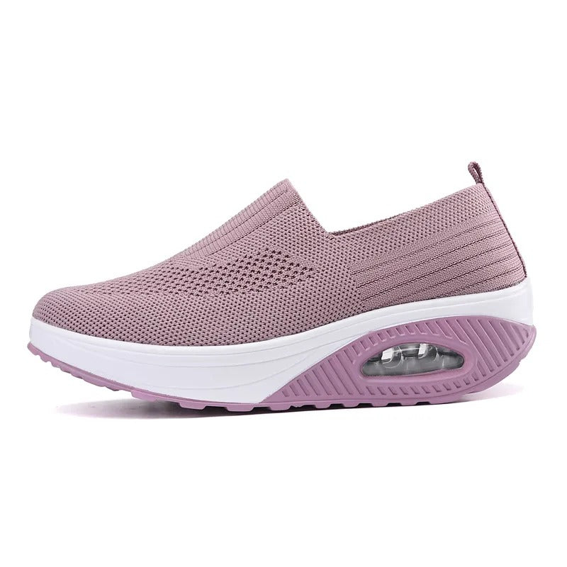 Mauve Fitlybuy women’s orthopedic slip-on sneaker with a thick white platform sole and cushioned air-pocket heel.