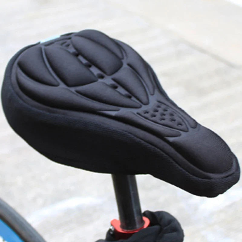 Black Fitlybuy gel bike seat cover with ergonomic padding, installed on a bicycle seat post.