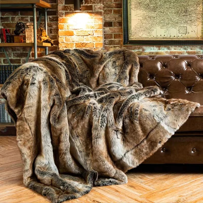 Fitlybuy brown faux mink fur throw blanket draped over a tufted leather sofa in a rustic brick room.