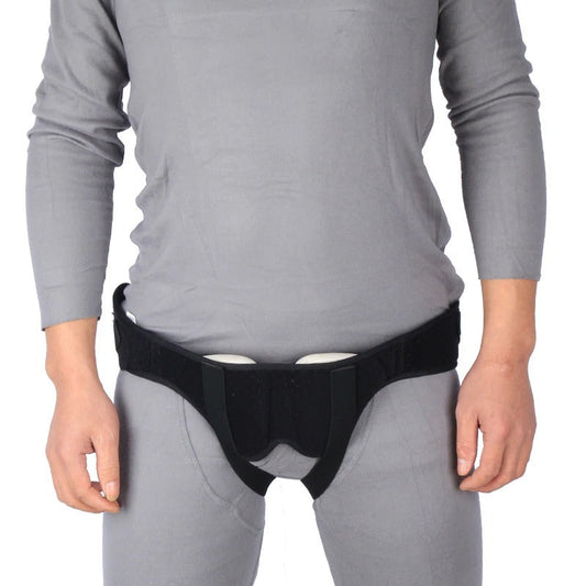 Fitlybuy black hernia support belt with adjustable compression pads worn over grey clothing for groin support.
