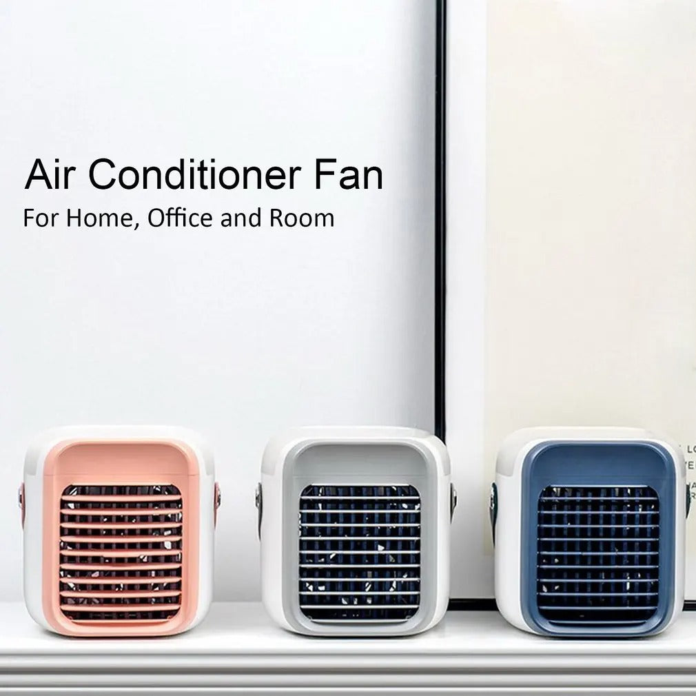 Three compact Fitlybuy 3-in-1 portable air conditioners in pink, grey, and blue sitting on a shelf.