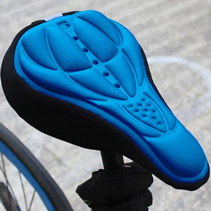 Fitlybuy blue gel bike seat cover with black sides, ergonomic contoured padding installed on a bicycle saddle.