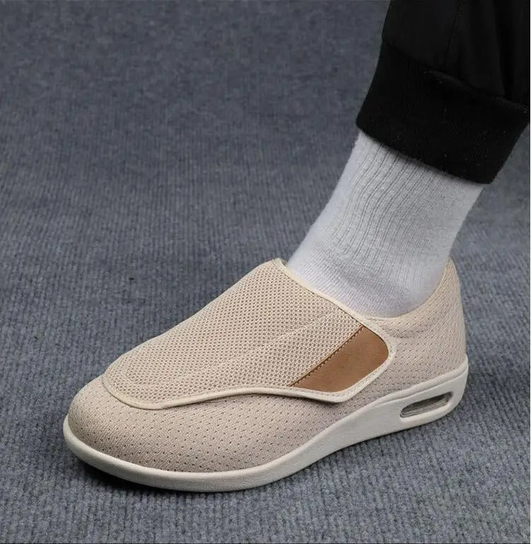 Beige Fitlybuy ComfortStride orthopedic walking shoe with mesh upper, Velcro strap, and cushioned air-sole heel.