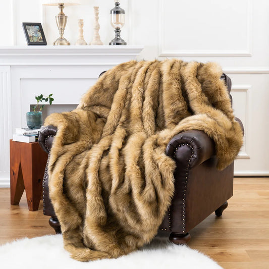 Fitlybuy luxury brown faux fox fur throw blanket draped over a dark leather armchair in a cozy living room setting.