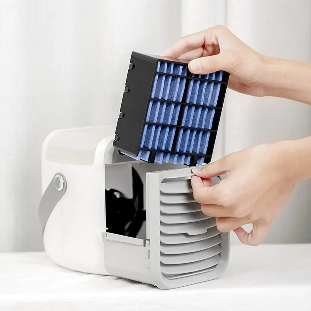 Hands inserting a blue cooling filter into a white and grey Fitlybuy 3-in-1 portable air conditioner.