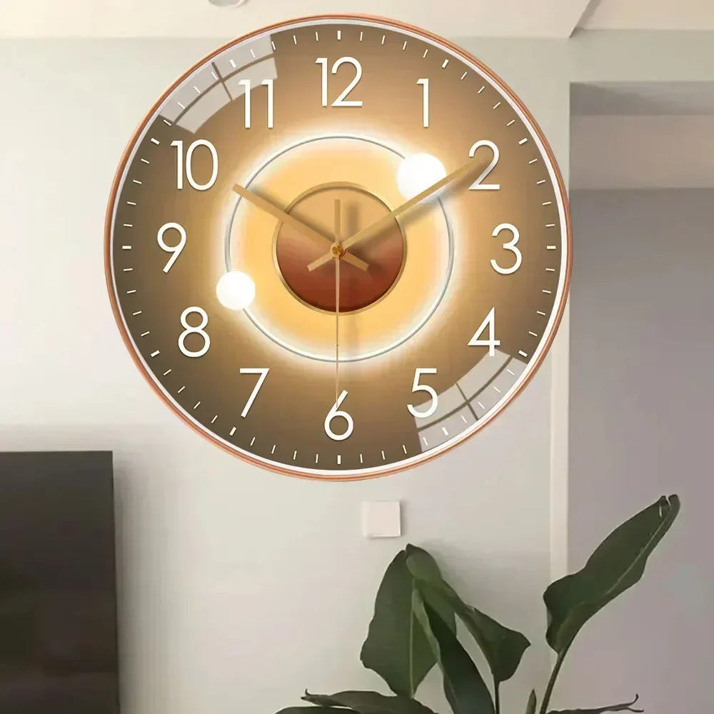 Fitlybuy silent gold-toned wall clock with a minimalist gradient face, white numbers, and slim hands on a home wall.