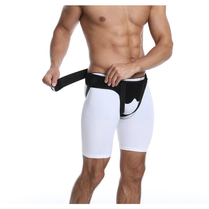 Man wearing a black Fitlybuy adjustable hernia support belt with compression straps over white compression shorts.