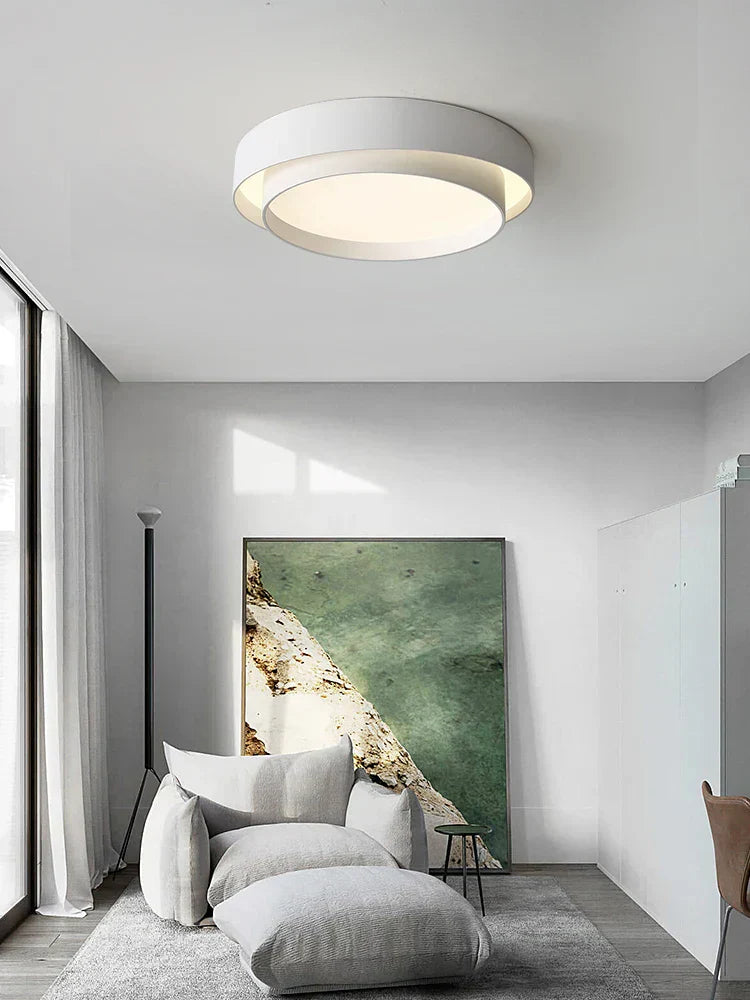 Fitlybuy NordicAura: White, tiered circular LED ceiling light with energy-efficient glow in a modern minimalist room.
