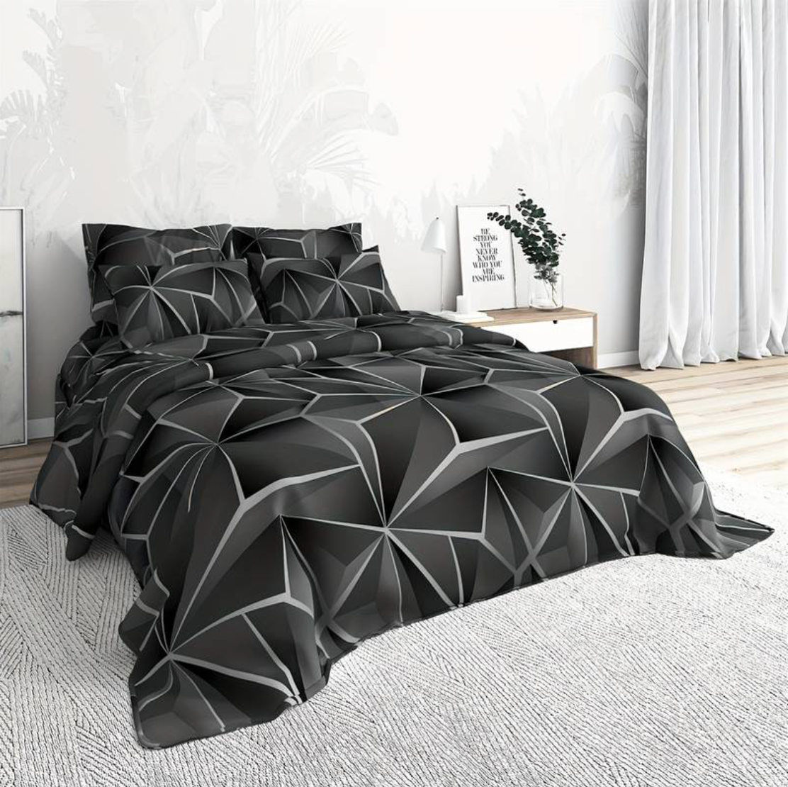 Fitlybuy Hilton black and grey geometric quilt set on a bed in a modern bedroom with white decor.