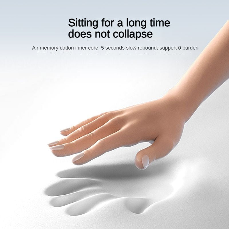 Hand pressing into white memory foam seat cushion, demonstrating slow-rebound material for pain-relieving back support.