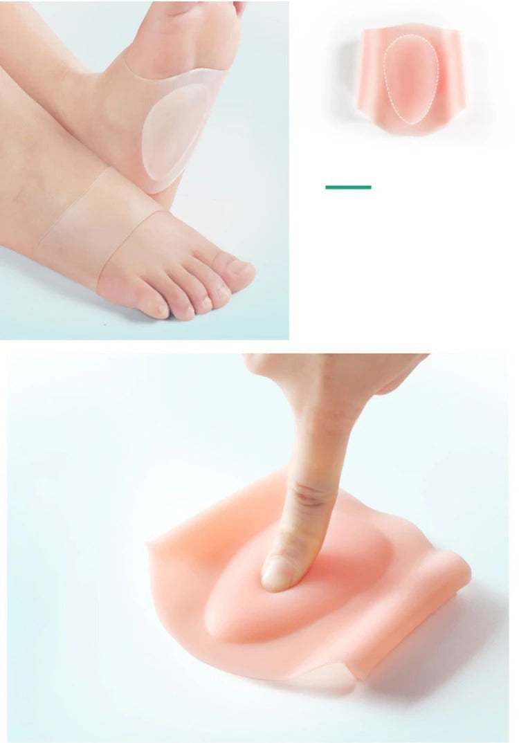 Beige silicone flat foot arch support wraps worn on feet and pressed by a finger to show flexible cushioning.
