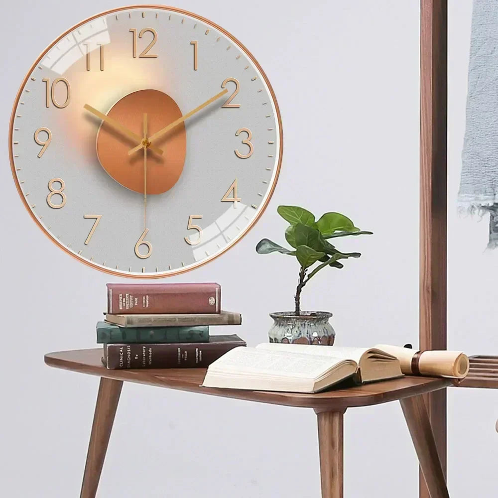 Fitlybuy silent wall clock with gold accents and a minimal design, displayed on a wall above a desk with books.