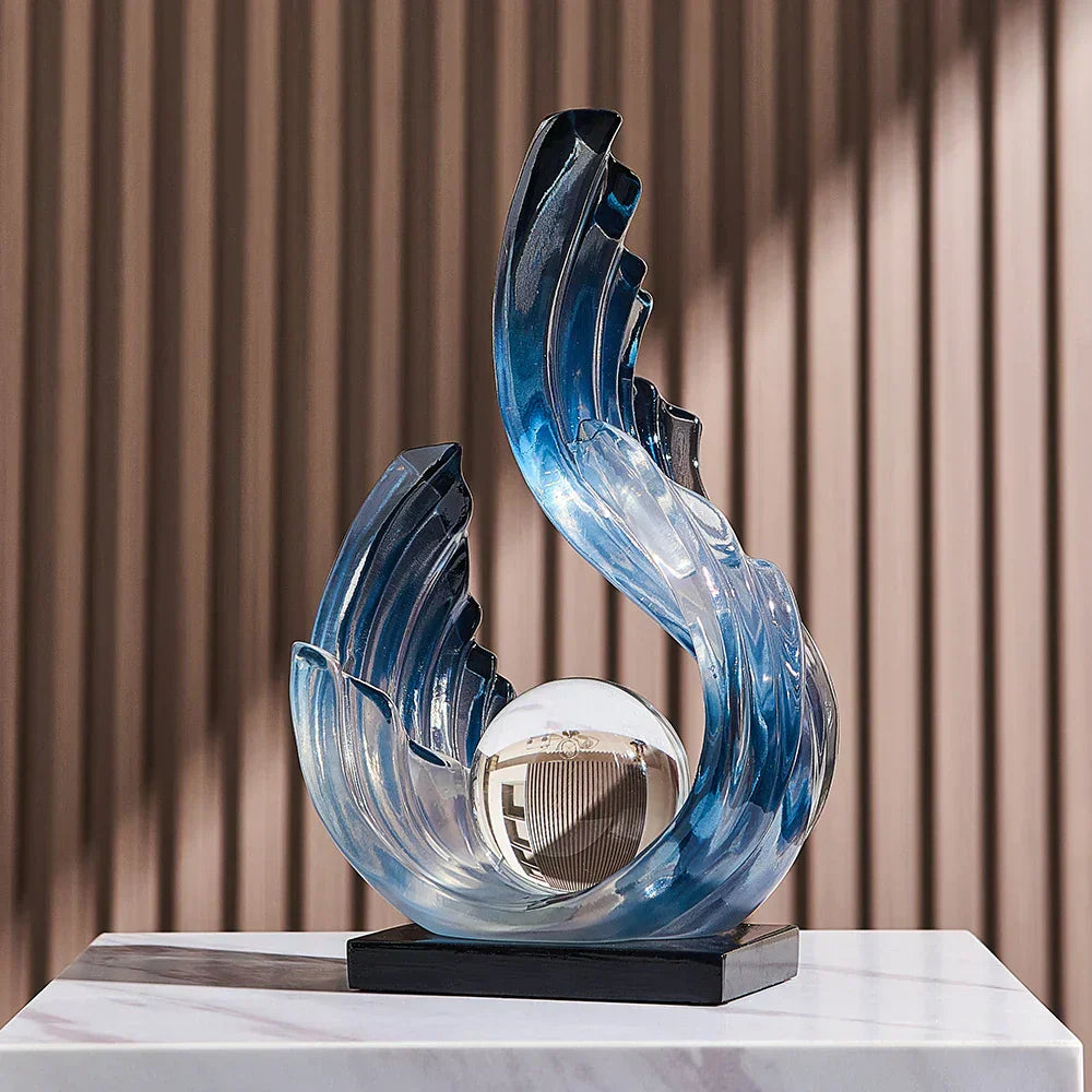 Fitlybuy Ethereal Flow glass ornament: blue wave-shaped sculpture with a central glass sphere on a black base.