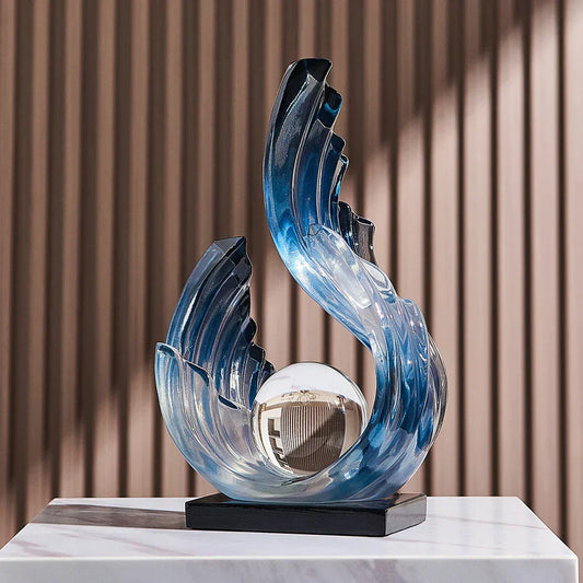 Fitlybuy Ethereal Flow glass ornament: blue wave-shaped sculpture with a central glass sphere on a black base.