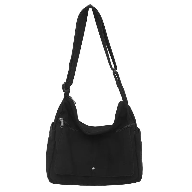 Fitlybuy black canvas shoulder sling bag with adjustable strap, zippered front pockets, and a slouchy, versatile design.