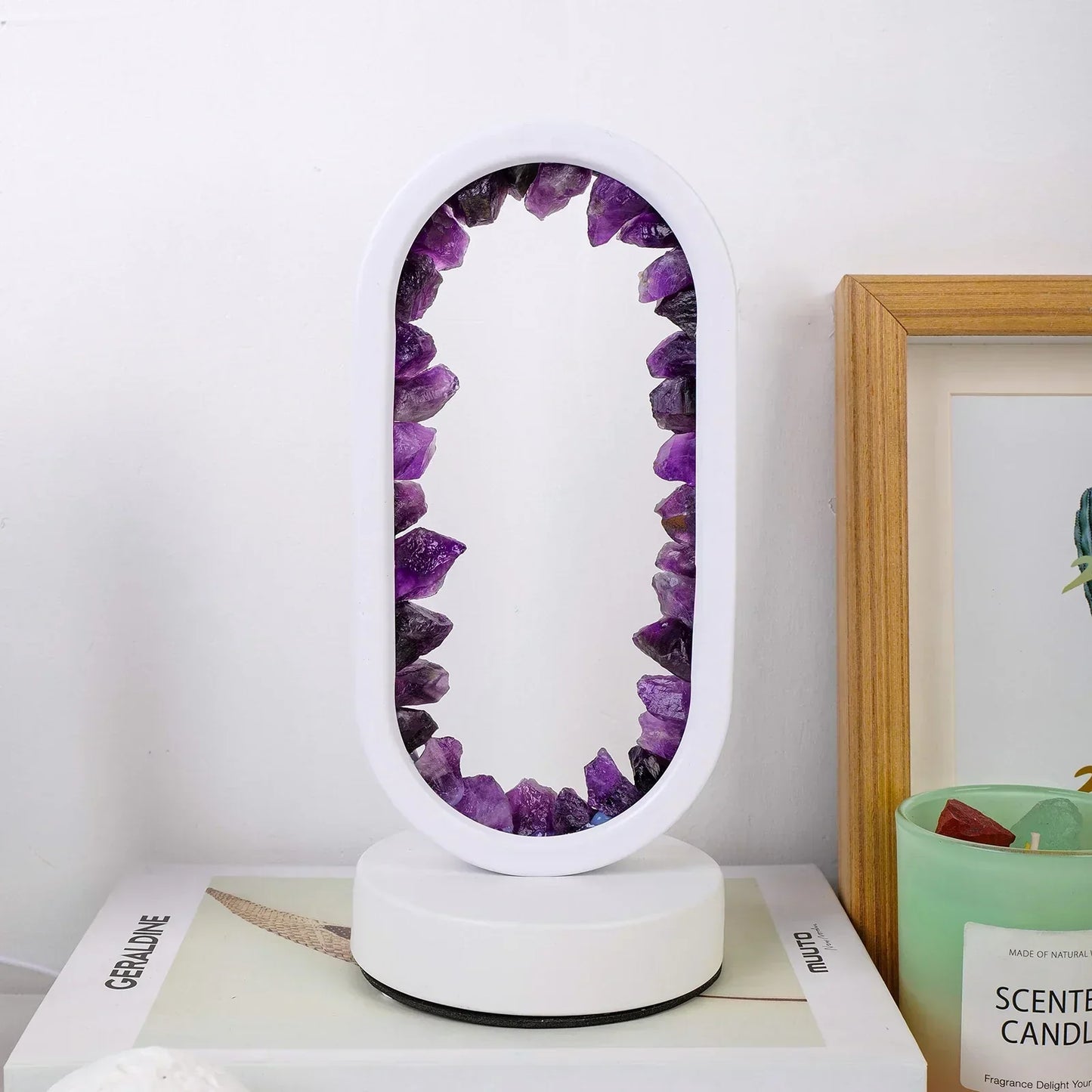 Fitlybuy AuraStone oval lamp with raw purple amethyst crystals in a white frame, displayed on a table near a candle.