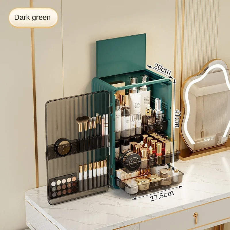 Dark green Luxo makeup organizer with dust-proof magnetic door, featuring tiered shelving and brush storage on vanity.