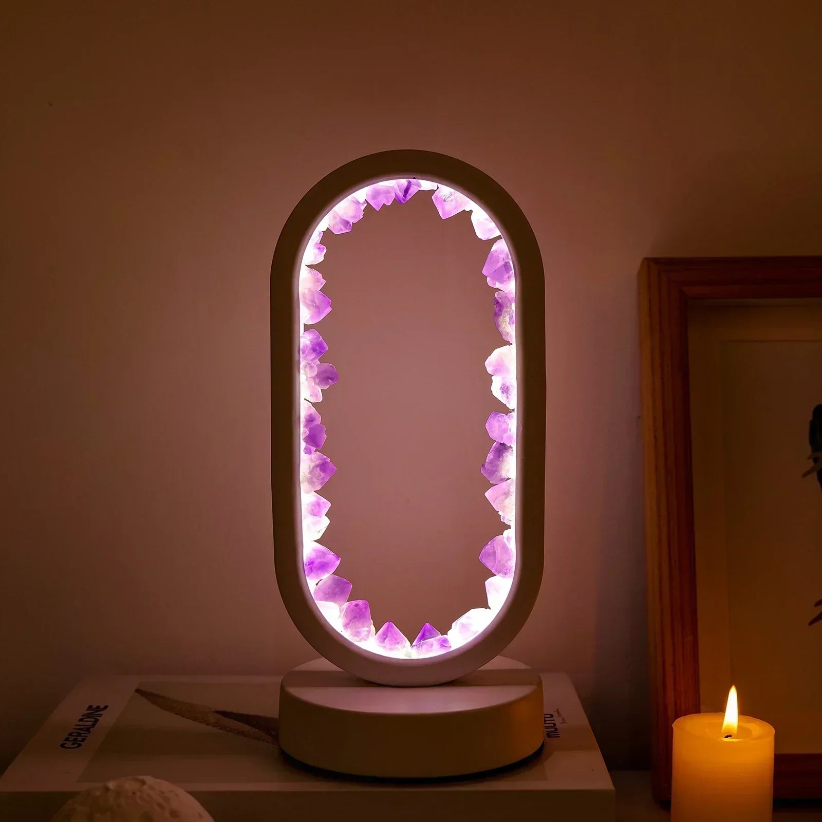 Oval Fitlybuy Amethyst Serenity lamp with backlit purple crystals on a wooden base in a warm, cozy room setting.