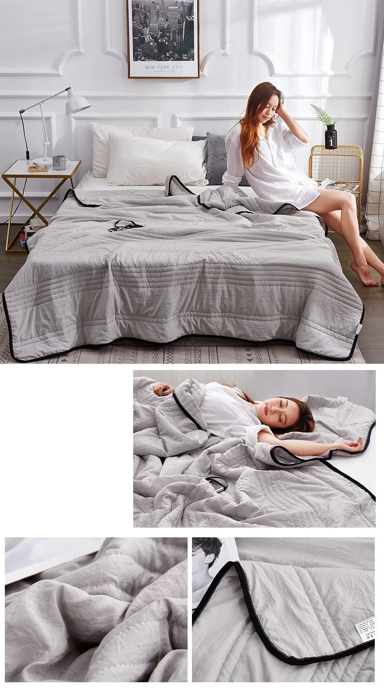 Fitlybuy premium grey cooling blanket with contrast black piping, showcasing ThermoRegulate fabric on a bedroom bed.