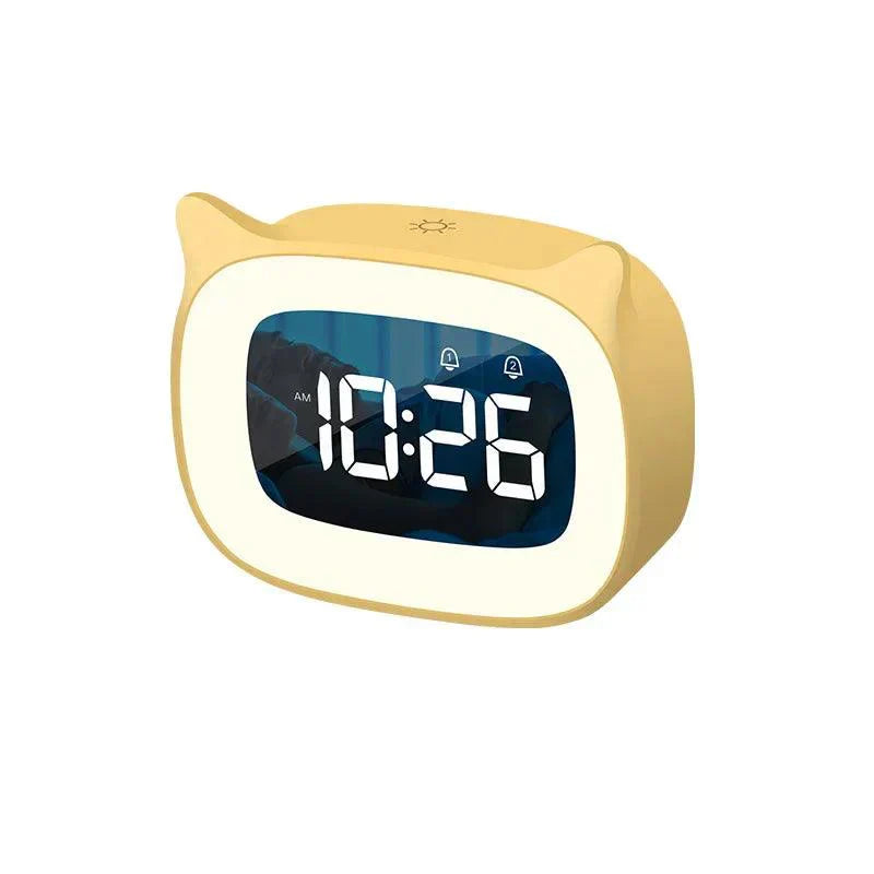 Yellow, cat-ear shaped LED alarm clock showing 10:26 AM, with dual alarm icons and a soft night light feature.