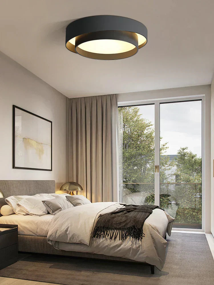 Fitlybuy NordicAura minimalist black-and-gold LED ceiling light installed in a modern, cozy bedroom.