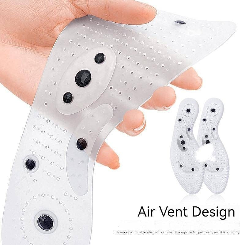 Clear, flexible Fitlybuy magnetic acupressure insoles with air vents being held by a hand.