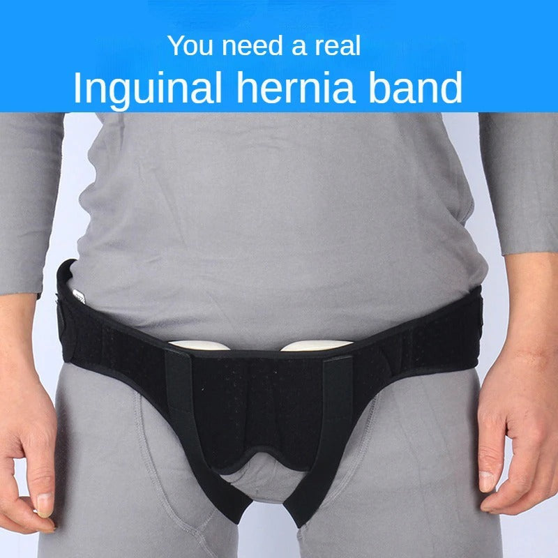 Fitlybuy black inguinal hernia support belt with adjustable compression pads worn over grey clothing.