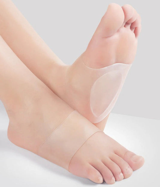 A pair of clear, silicone ComfortFlex arch support insoles worn on bare feet to provide cushioning for flat feet.