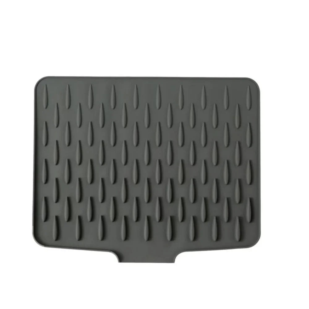 Dark gray silicone drying mat with raised, teardrop-shaped ridges for drainage and non-slip, heat-resistant surface.