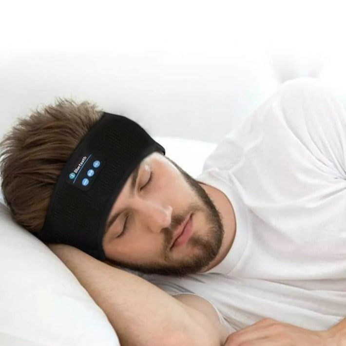 Man sleeping wearing a black Fitlybuy Bluetooth sports headband with integrated HD stereo control buttons.