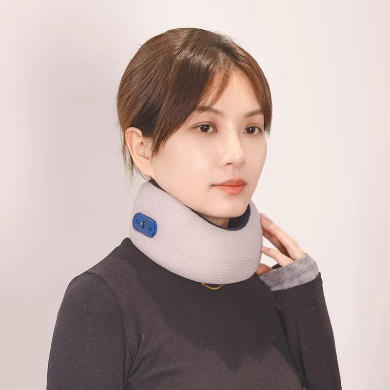 A person wears a light gray Fitlybuy smart heated neck brace with a visible blue control button on a white background.