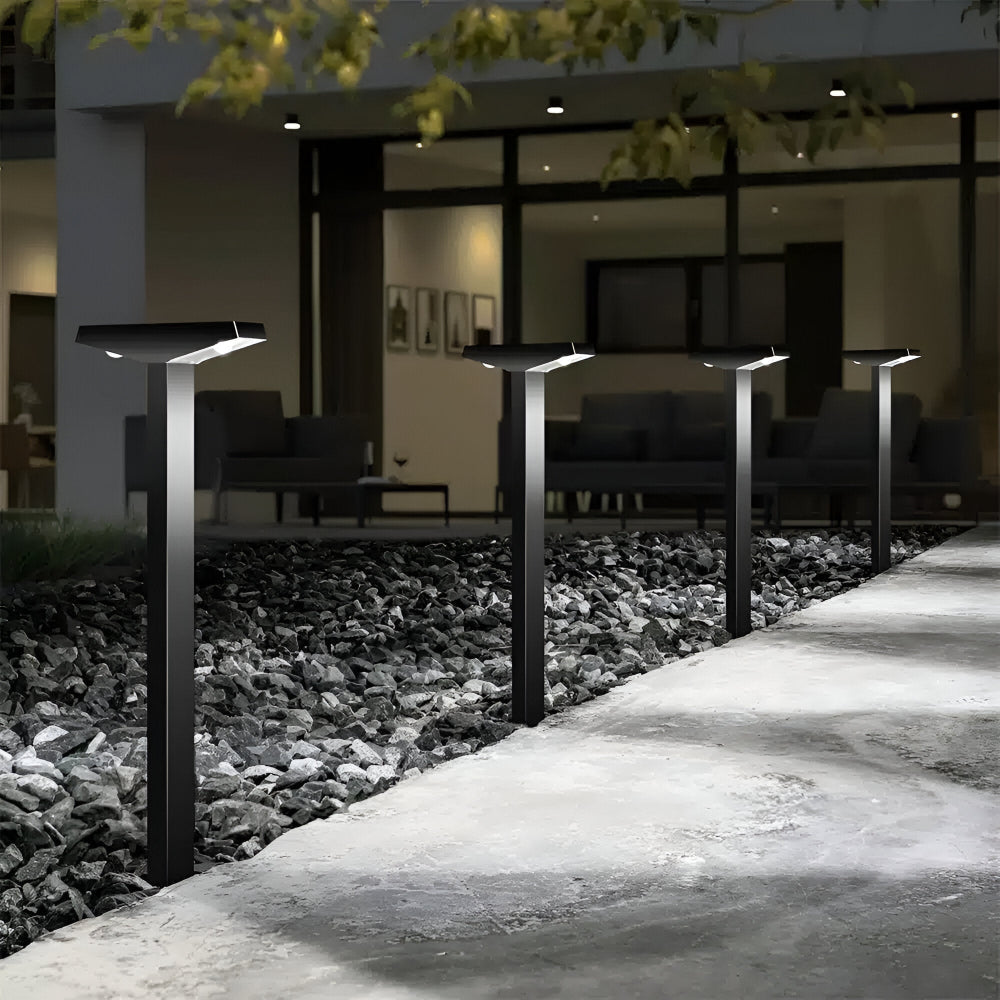 Black Fitlybuy SolaraPath solar lights line a stone garden path at night, casting soft light on the walkway.
