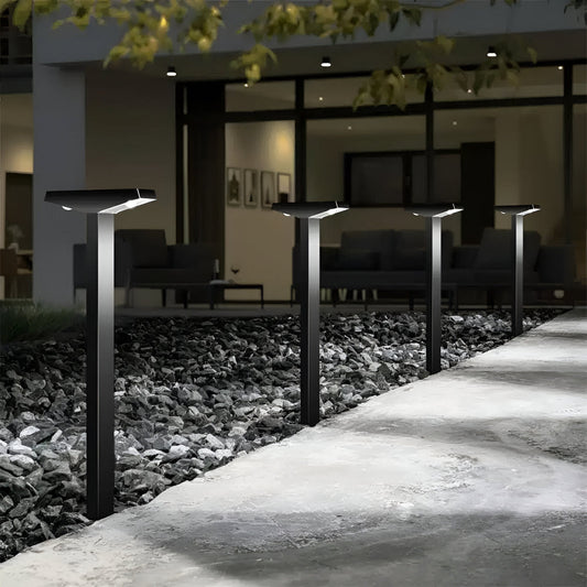 Black Fitlybuy SolaraPath solar lights line a stone garden path at night, casting soft light on the walkway.